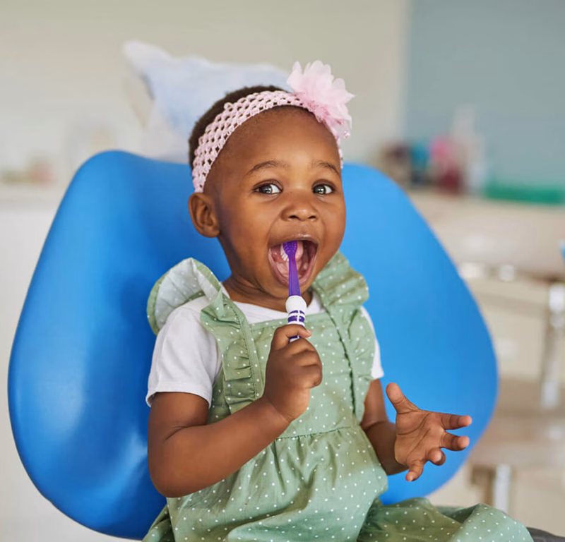 toddler girl with toothbrush