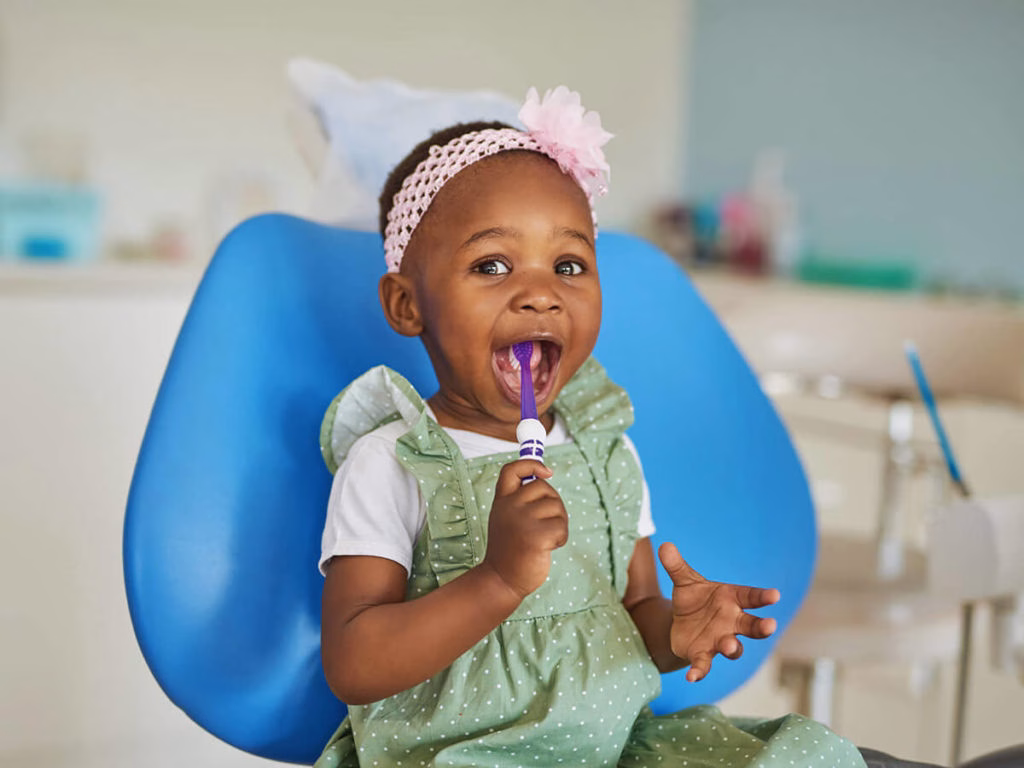 toddler girl with toothbrush